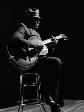 African American man playing guitar
