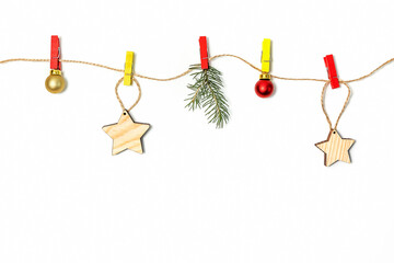 Christmas and new year holiday composition. Christmas decorations hang on colored clothespins on a rope white background. copy space.