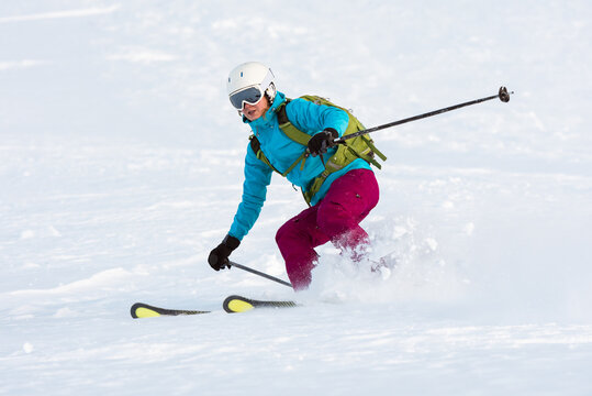 Woman skiing in deep snow off piste