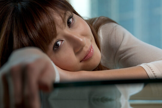 Woman leaning on table