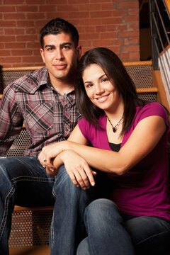 Smiling couple sitting on stairs