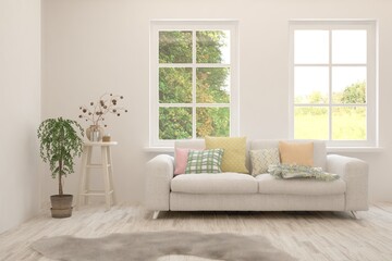 White living room with sofa and summer landscape in window. Scandinavian interior design. 3D illustration