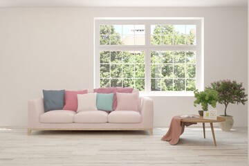 White living room with sofa and summer landscape in window. Scandinavian interior design. 3D illustration