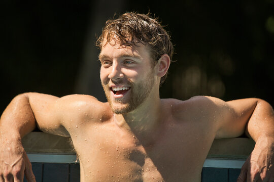 Caucasian man relaxing in swimming pool