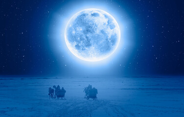 Horses pulling sleigh in winter Full Blue Moon in the background - Cildir Lake, Kars "Elements of this image furnished by NASA "