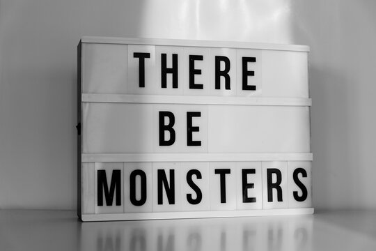 Lightbox with the words There Be Monsters