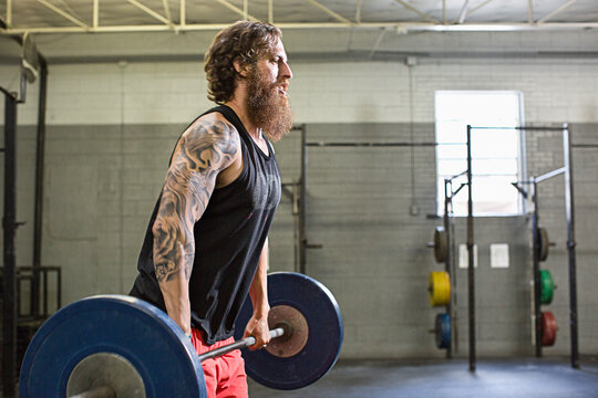 Caucasian athlete lifting weights in gym