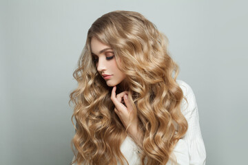 Young pretty woman with healthy curly blonde hair, beauty fashion portrait