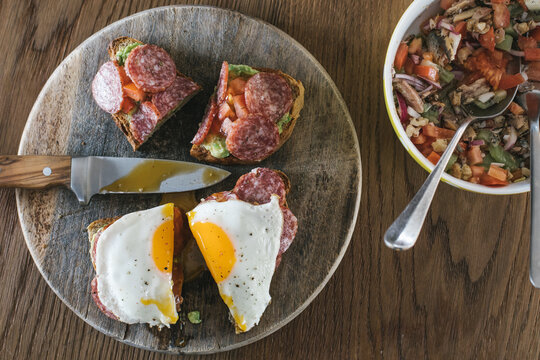 olive bread with avocado spread, salami and egg and sardine, kiw