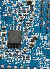 microchip and components on blue electronic pcb closeup