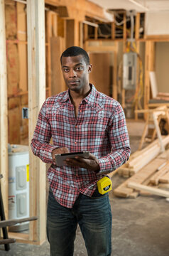 Worker using tablet computer at construction site