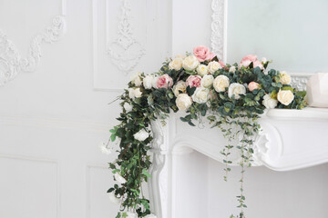 white interior flowers. white mantelpiece with flowers