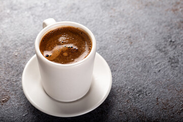 Cup of espresso. Cup of hot coffee on stone background.