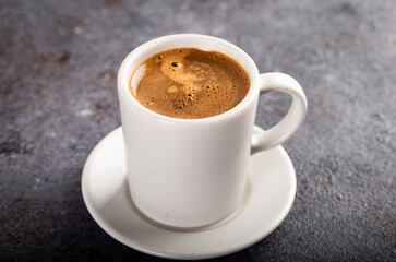 Cup of espresso. Cup of hot coffee on stone background.
