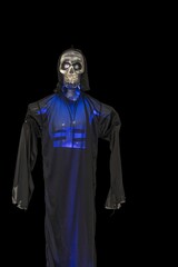 View of blue lighted skeleton head on black background. Halloween concept.