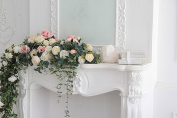 white interior flowers. white mantelpiece with flowers