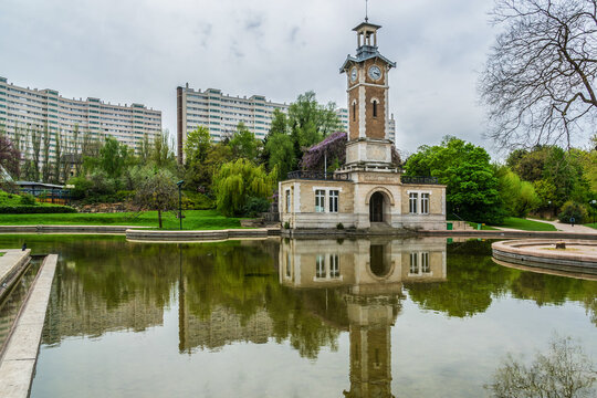 Park George Brassens is a public park located in the 15th arrondissement on the site of a former fish market. Pond and Clock tower in the Parc Georges-Brassens. Paris, France.