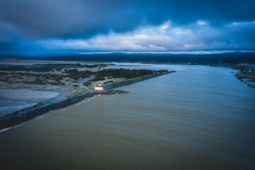 Aerial of lighthouse in Bandon, Oregon, USA with storm clouds. 