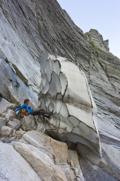 Male rock climber trying to tumble down a large piece of ice
