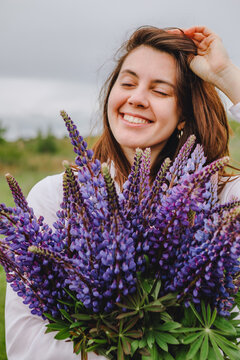 woman at blooming lupines field