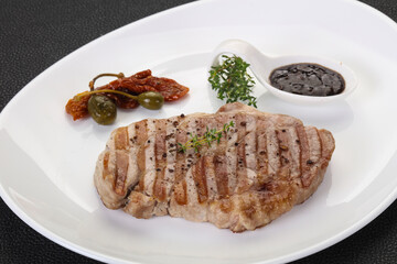 Grilled pork steak with pepper sauce