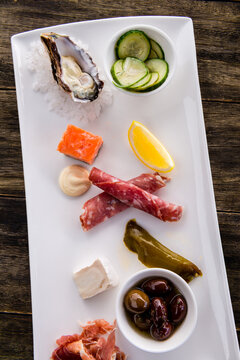 local produce platter with oyster, salmon, olives, cheese, small