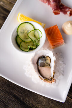 local produce platter with oyster and pickled cucumbers
