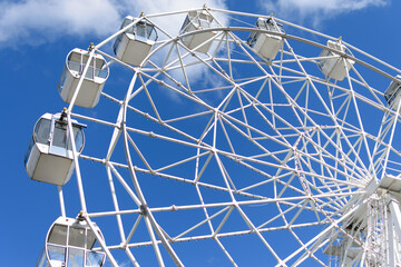 Ferris Wheel attraction against the sky, close-up from below.