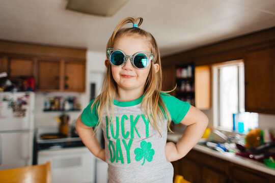Toddler child in Lucky Day Saint Patrick's Day shirt in kitchen.
