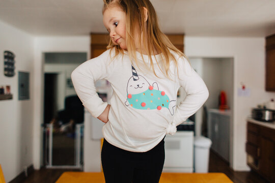 Cute toddler girl in narwhal shirt.