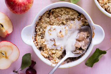 Apple crumble with ice cream on pink textile