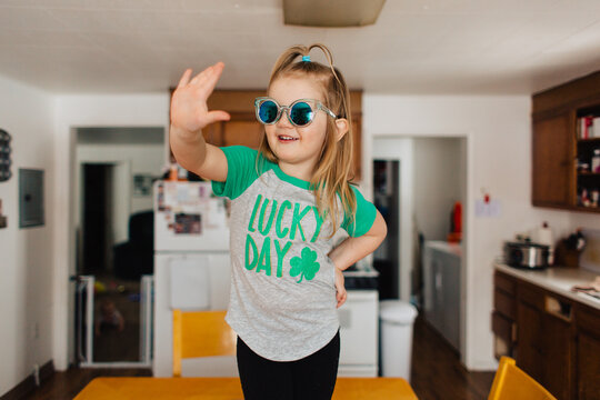 Toddler child in Lucky Day Saint Patrick's Day shirt in kitchen.