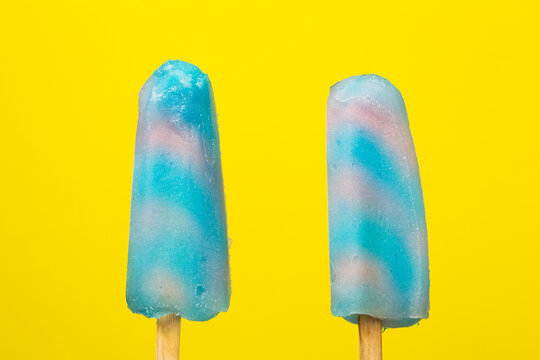 Frozen popsicles on a yellow background