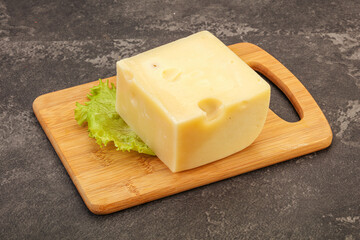 Emmental cheese over wooden board