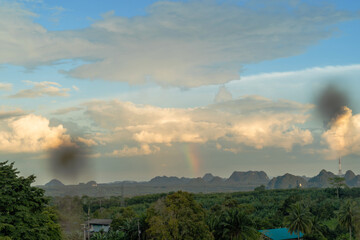 Sky background with rainbow, near mountain