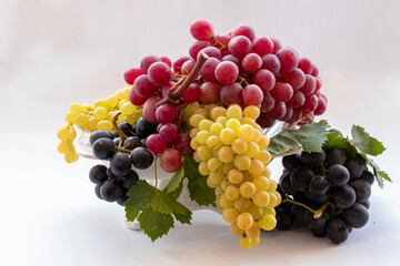 Black, yellow and red grapes on a white background