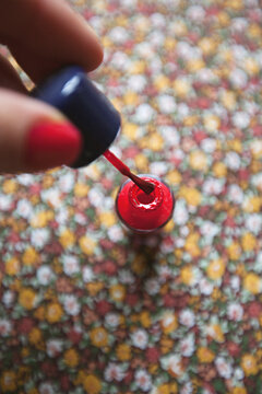 close up of woman's hand with red nail polish