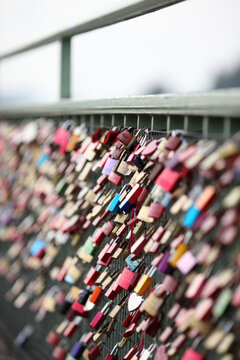 Love locks hanging on the railing of bridge