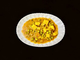 Mutter Panneer or green peas cheese cottage curry served in a plate