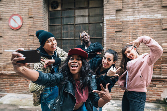 Group of dancers taking a selfie in the street.