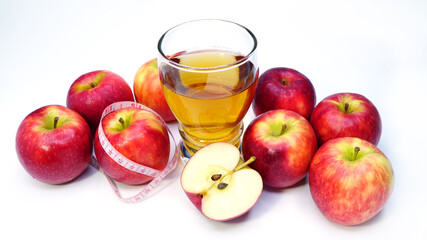 apple cider vinegar,apple and apple juice with tape measure on white background, healty food, drink for weight control in summer.	