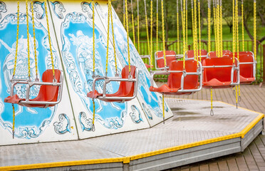 Part of a multicolored carousel in an empty amusement park in late summer