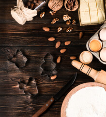 Kitchenware,  almond nuts, flour, eggs, butter,   on wooden background , top view.