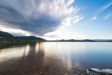 Vue en longue exposition sur le lac du Salagou par temps nuageux (Occitanie, France)