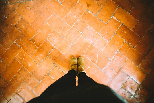 Feet on a terracota tiles floor