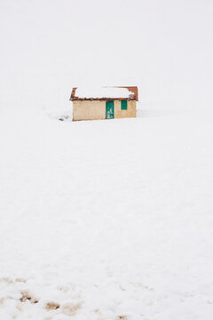 Lonely house by the mountain,covered by snow