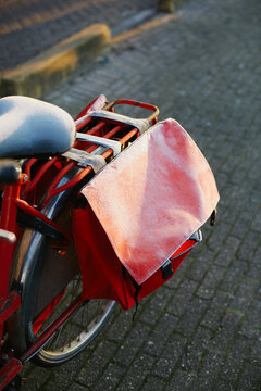 Parked red urban bicycle with frosty panniers