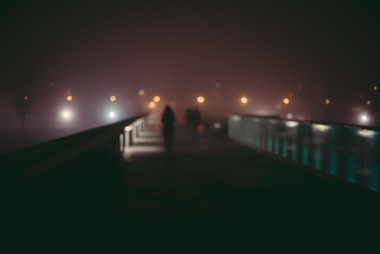 Urban and night photography of a mysterious foggy street.