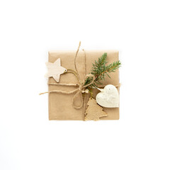 Christmas gift in kraft paper isolated on white background. Eco and natural wrapping with twine. Plastic free. Boxes with gifts in reusable sustainable recycled paper. Eco friendly homemade new year