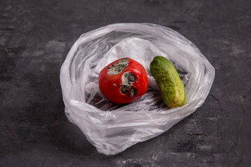 Food waste. spoiled tomato, rotten cucumber. Black mold on food. Improper storage of vegetables